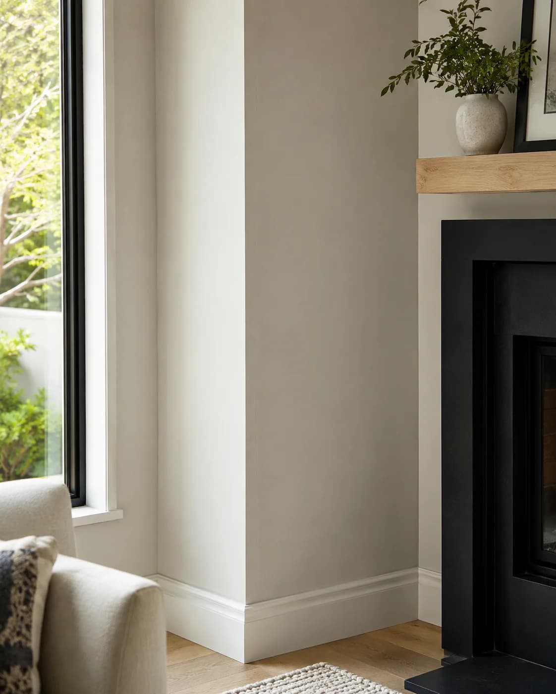 Freshly painted interior accent wall beside a black fireplace surround