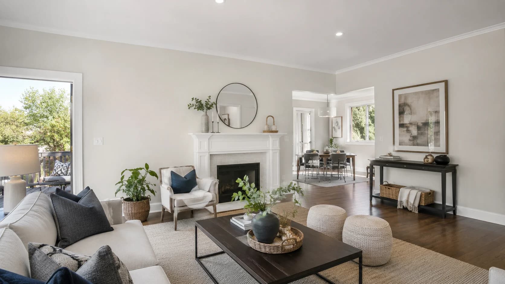 Open living room with a fireplace opening into a connected dining area