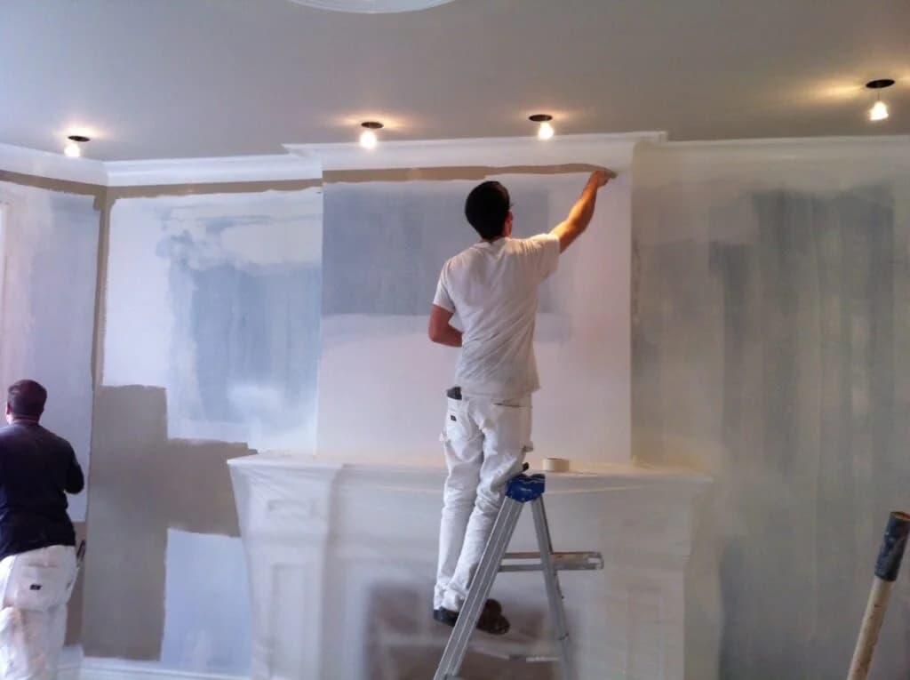 Freshly painted interior accent wall beside a black fireplace surround